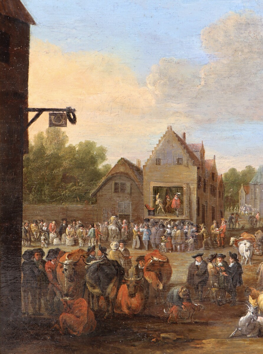 A cattle market, a theatre company performing in the background