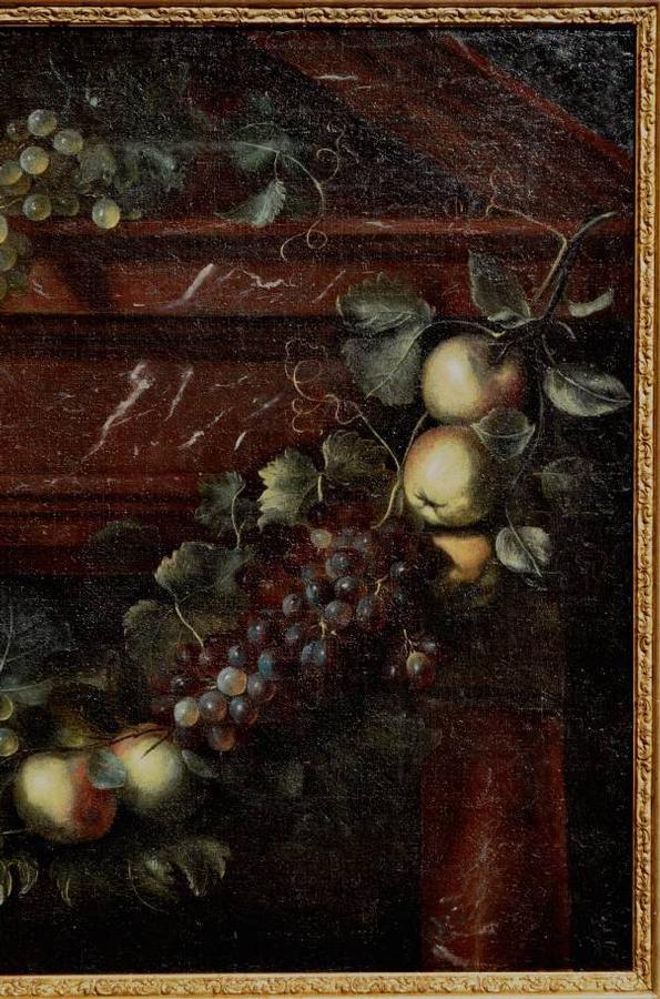 A swag of fruit against an architectural background