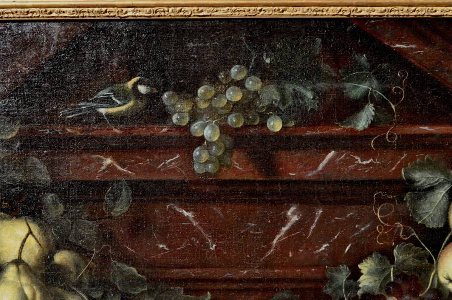 A swag of fruit against an architectural background