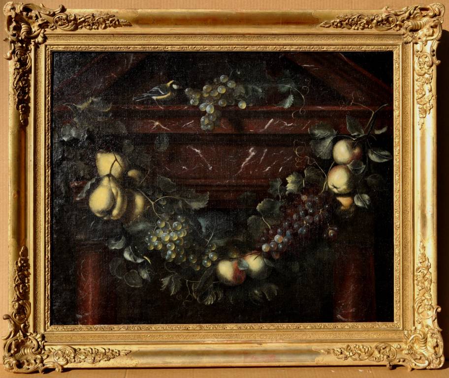 A swag of fruit against an architectural background