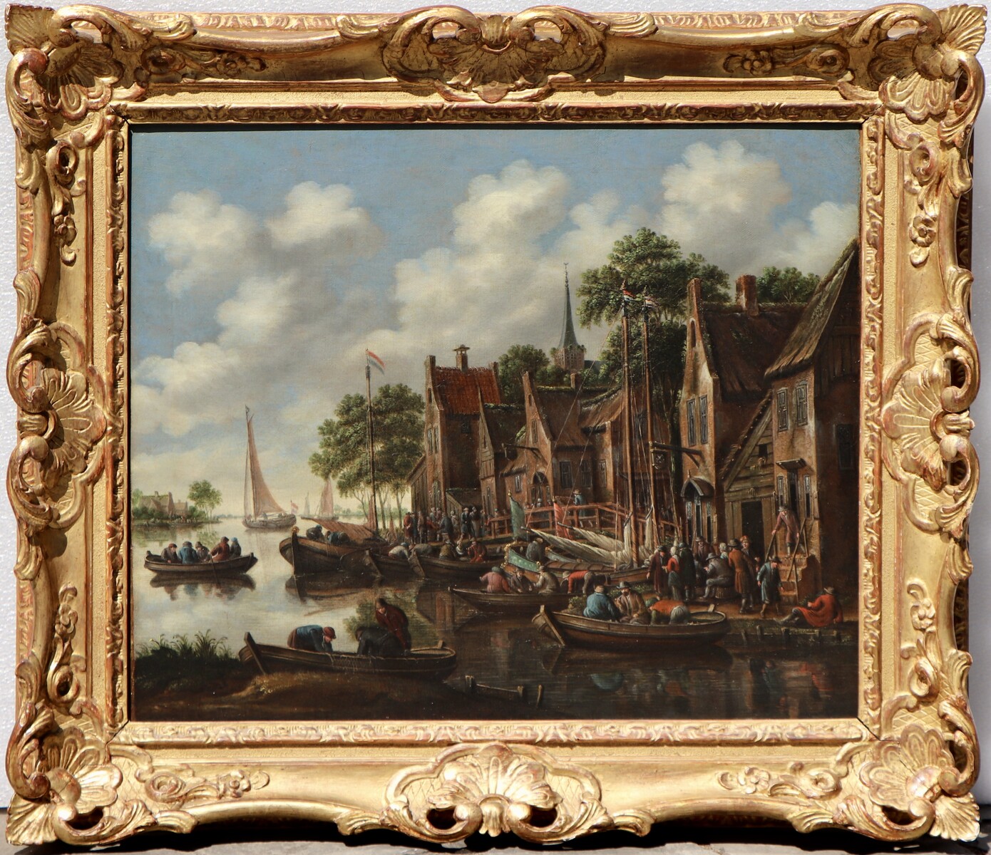 A bustling summer village scene along a river