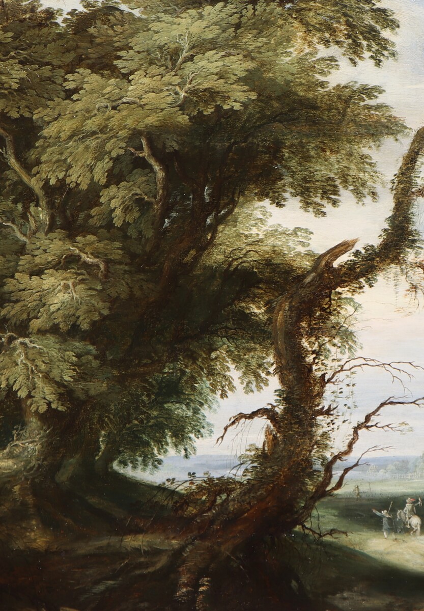 A falconer in a partly wooded landscape