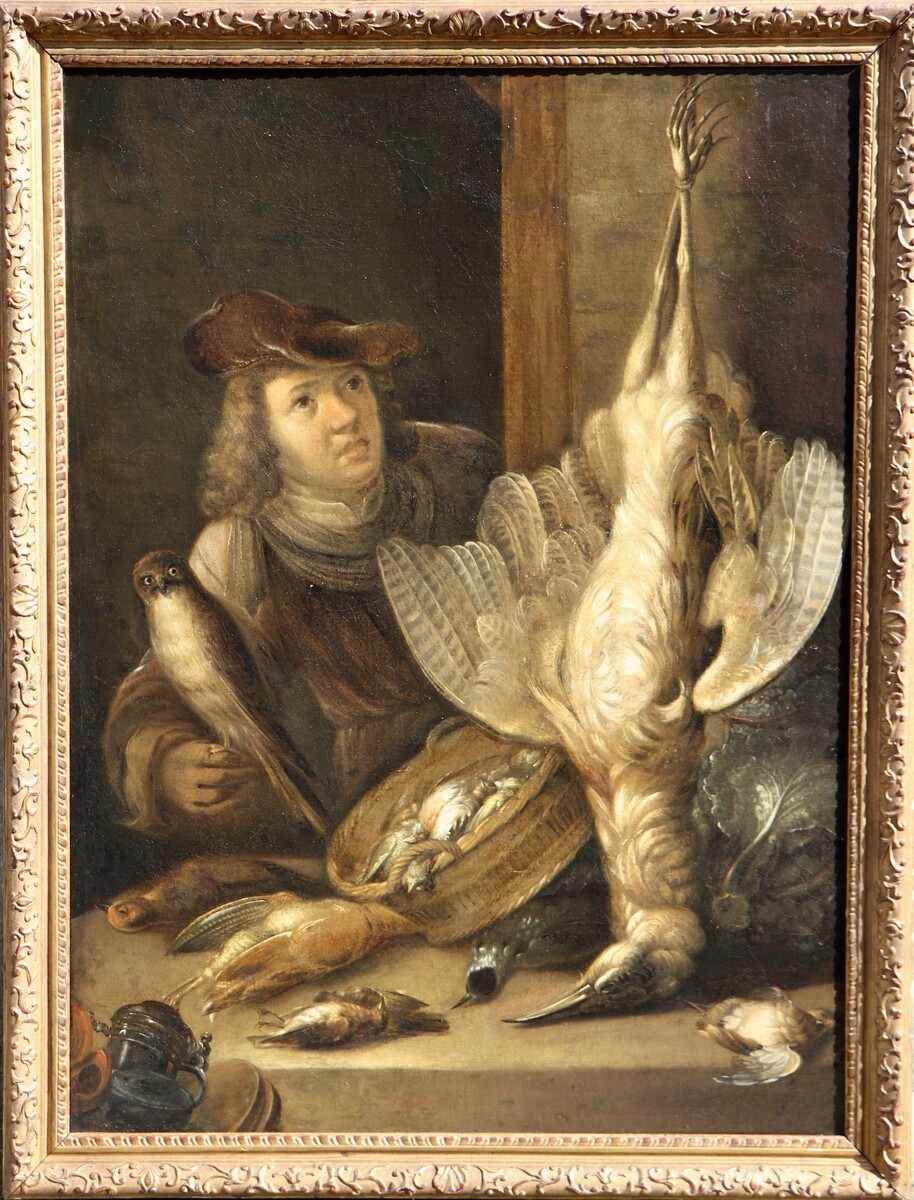 A falconer posing with his catch