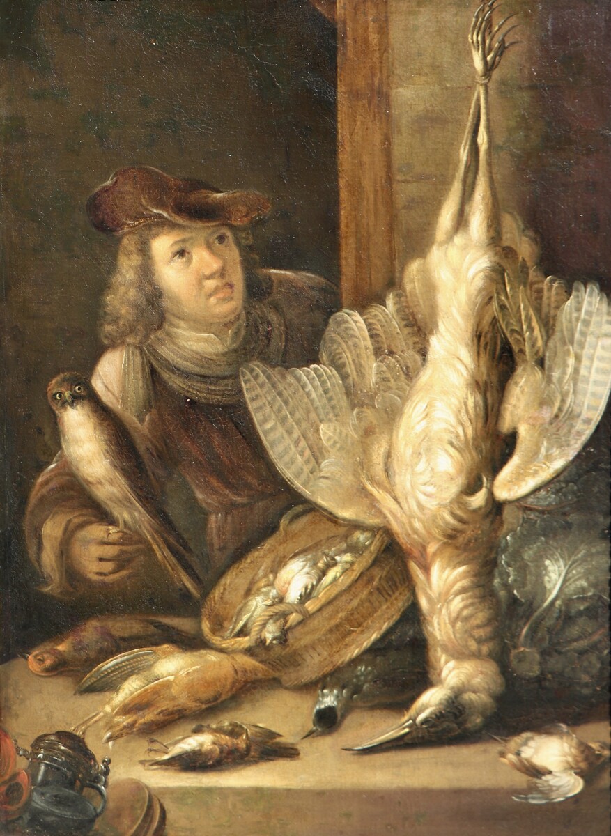 A falconer posing with his catch