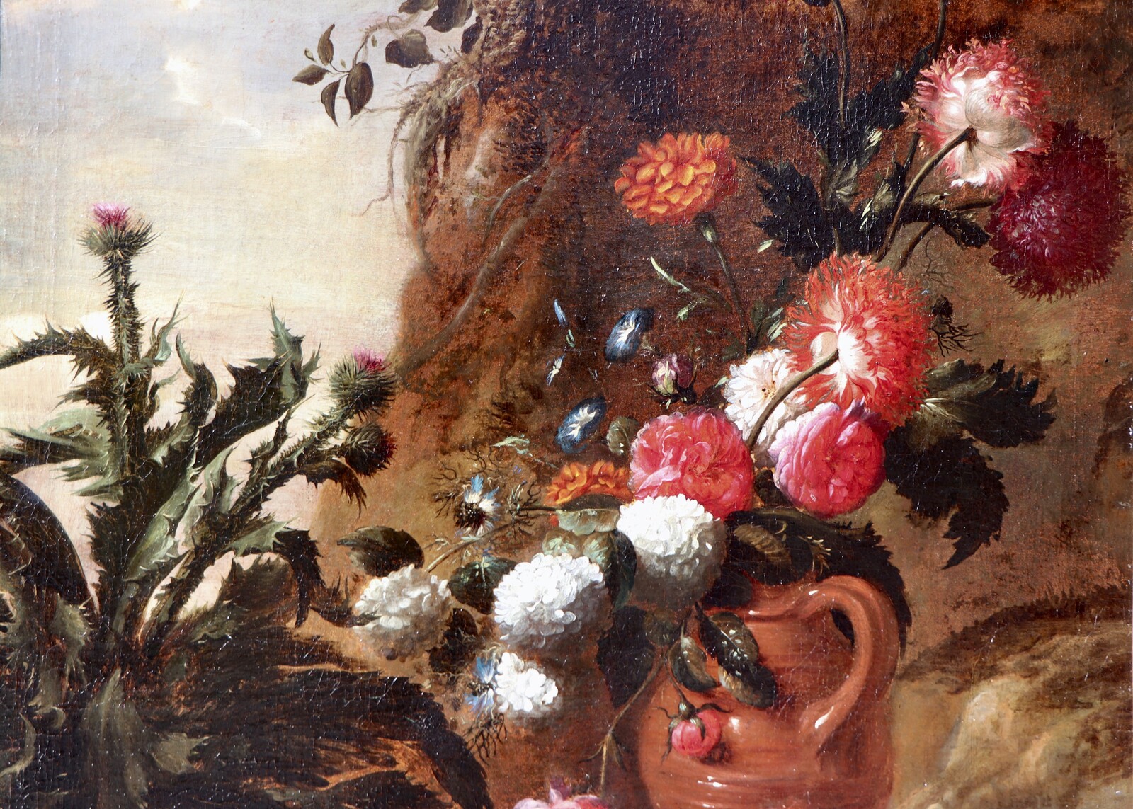 A forest floor with a thistle, a flowered jug and two frogs