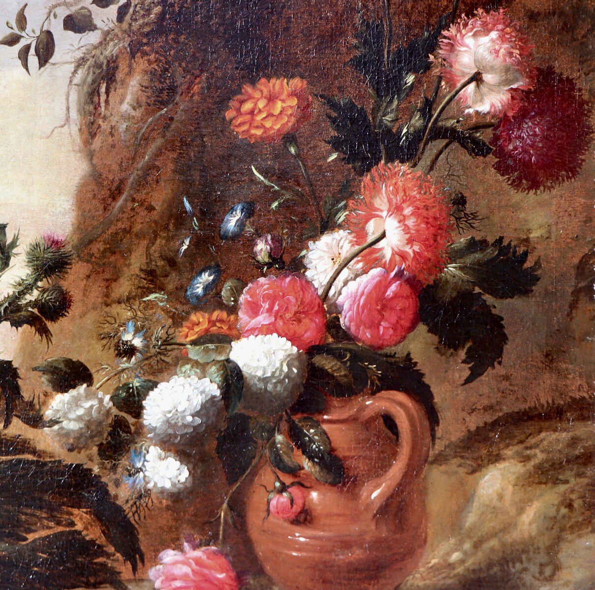 A forest floor with a thistle, a flowered jug and two frogs