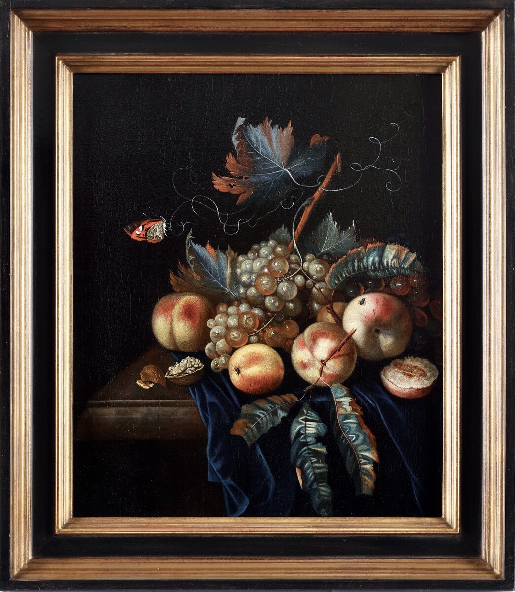 A fruit still life with peaches and grapes, a butterfly and a fly