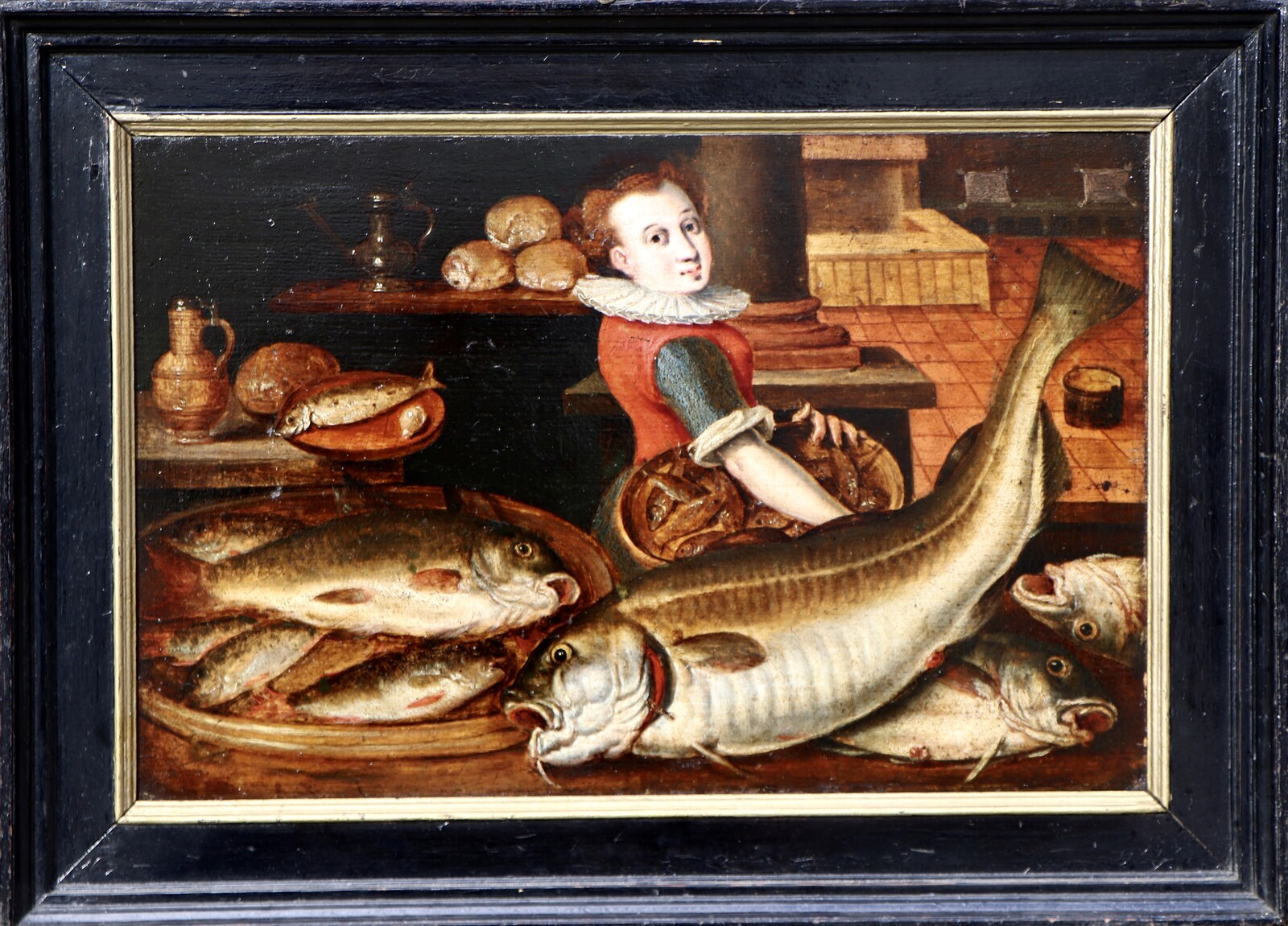 A woman in a kitchen filled with fish