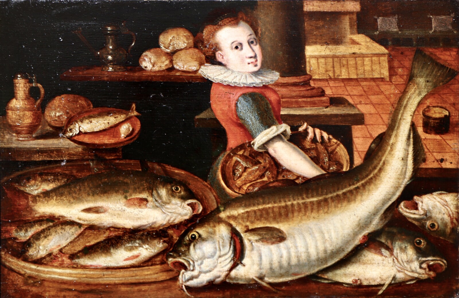 A woman in a kitchen filled with fish