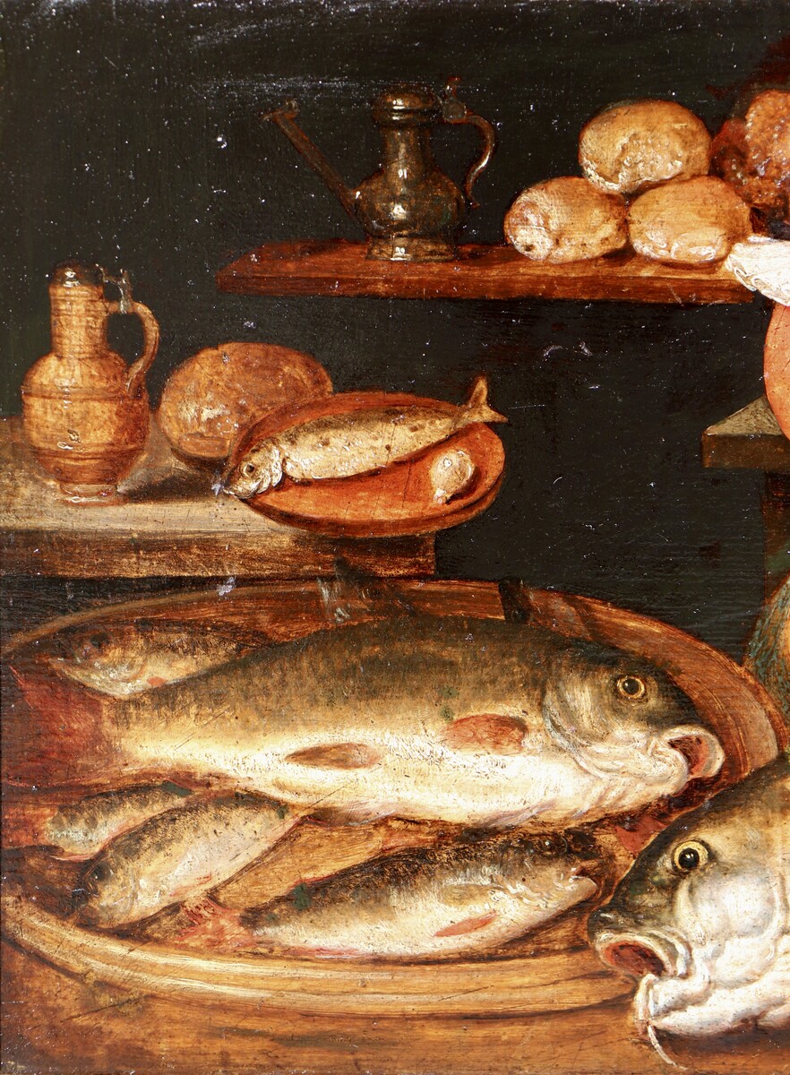 A woman in a kitchen filled with fish