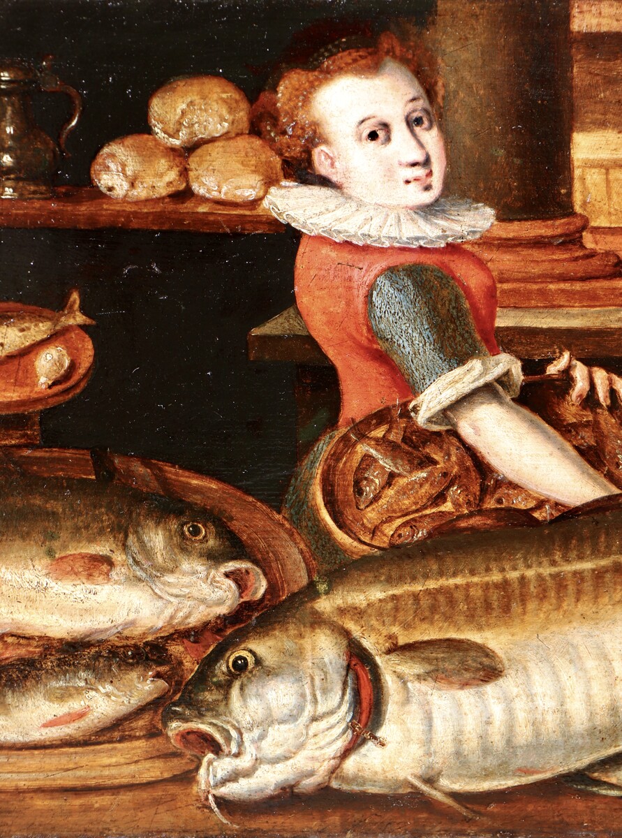 A woman in a kitchen filled with fish