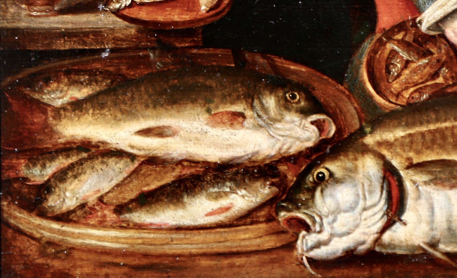 A woman in a kitchen filled with fish