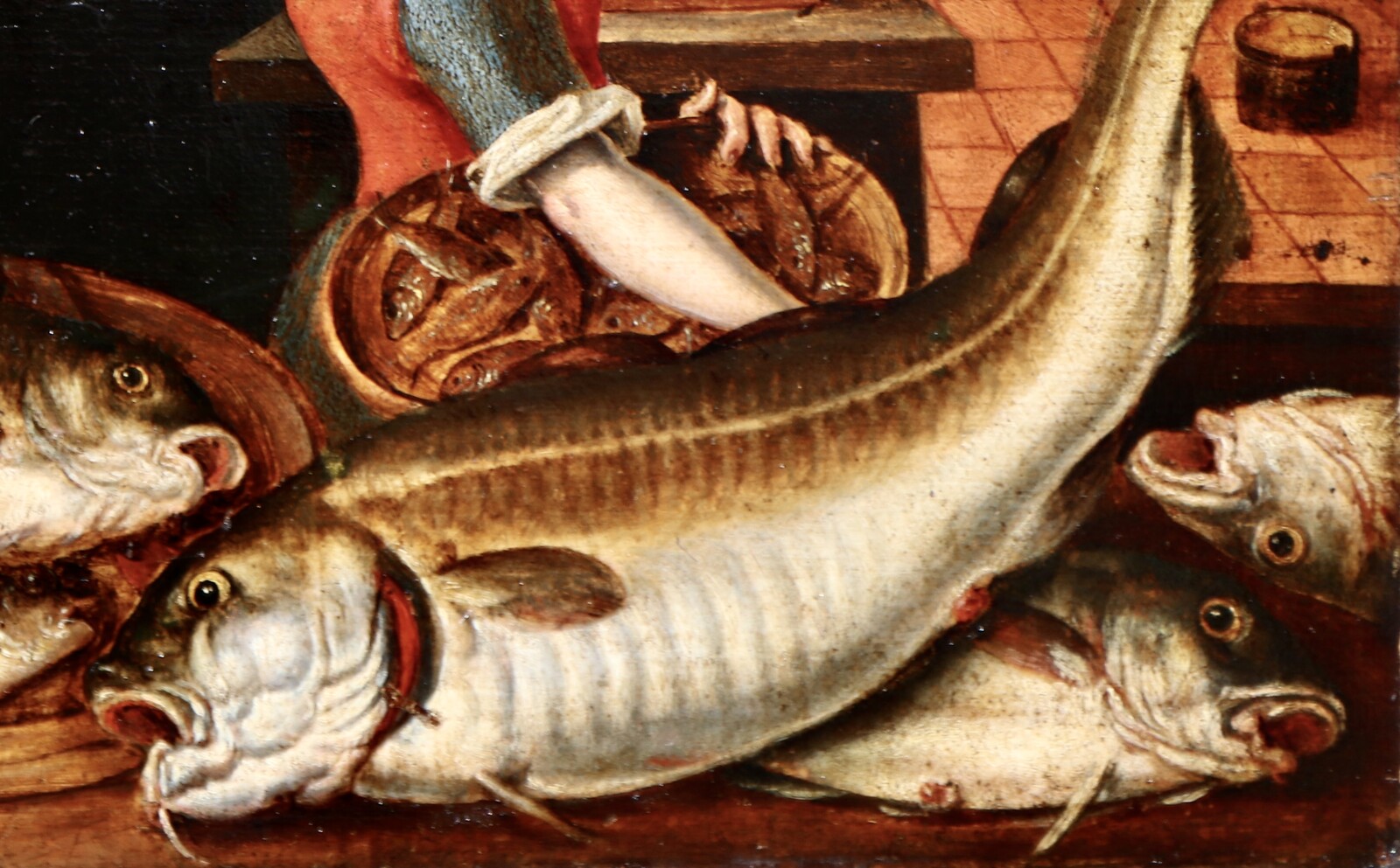 A woman in a kitchen filled with fish