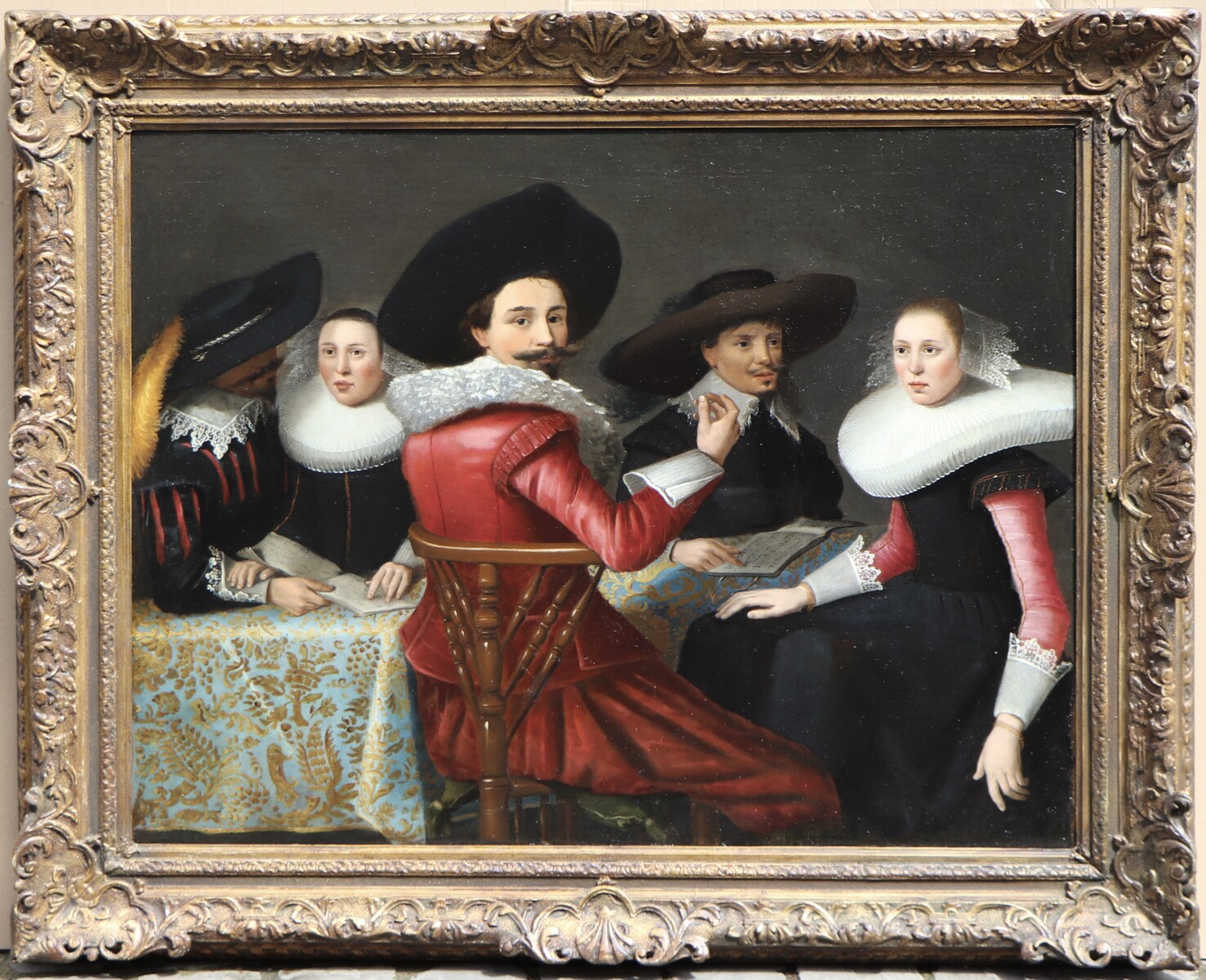 An elegant company of five people singing