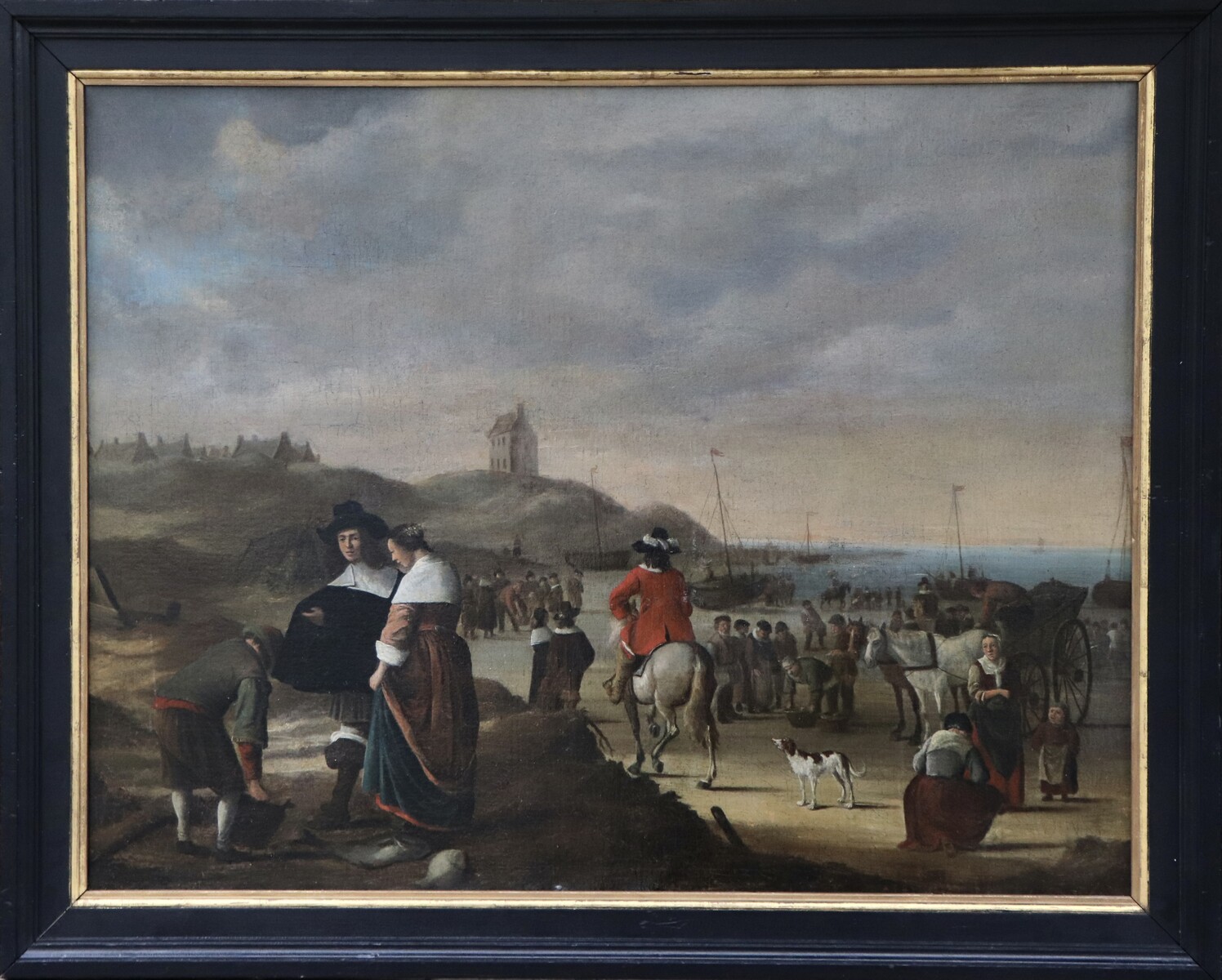 An elegant couple buying fish on the beach