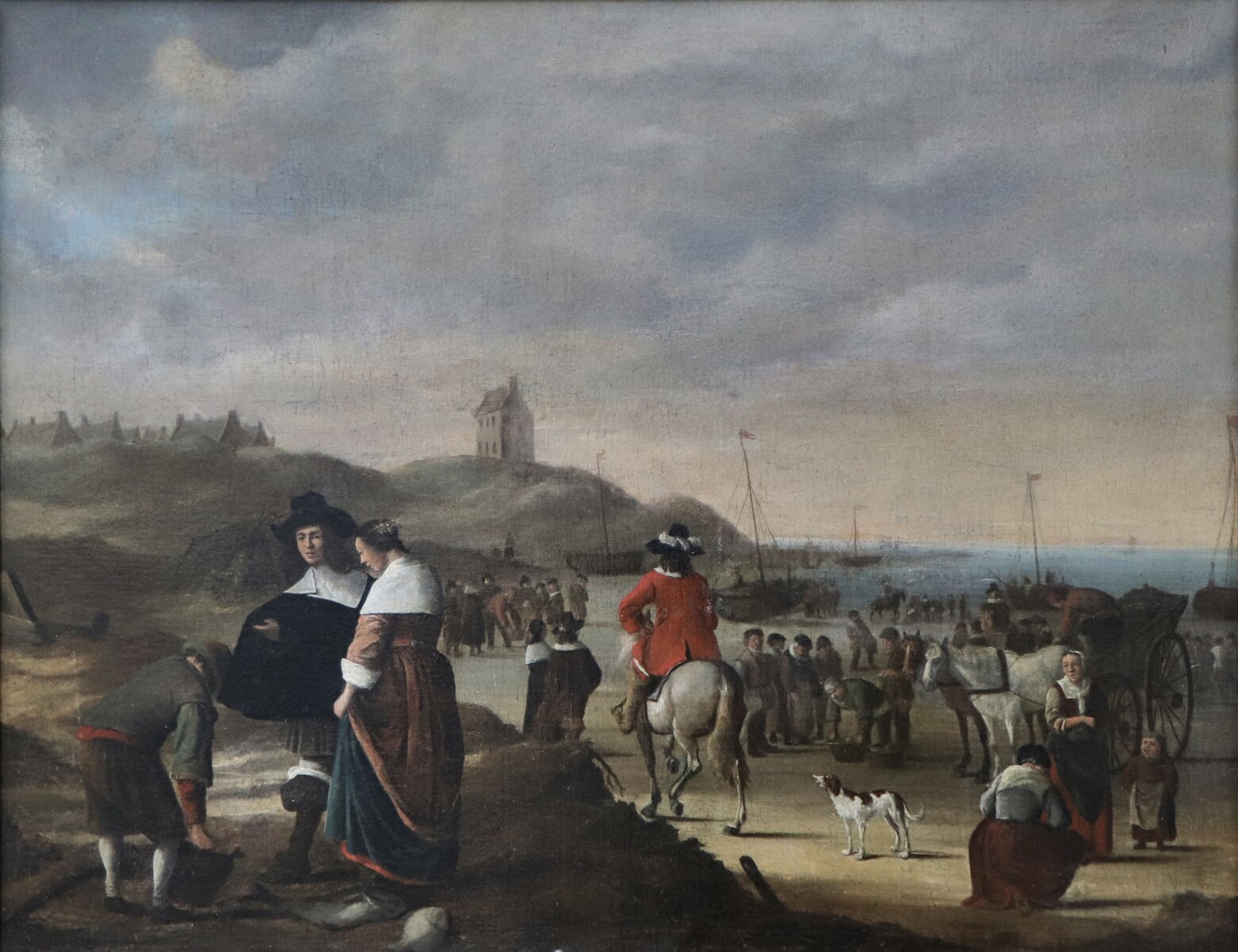 An elegant couple buying fish on the beach