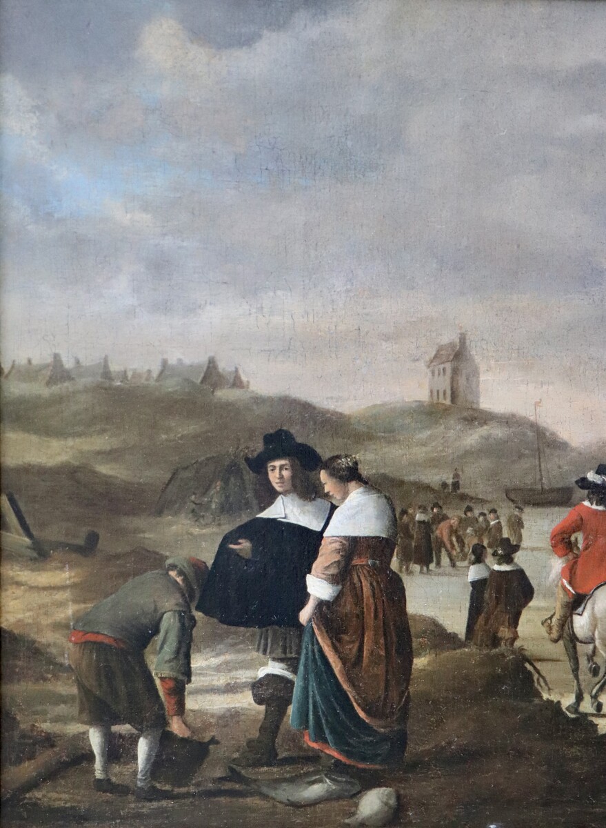 An elegant couple buying fish on the beach