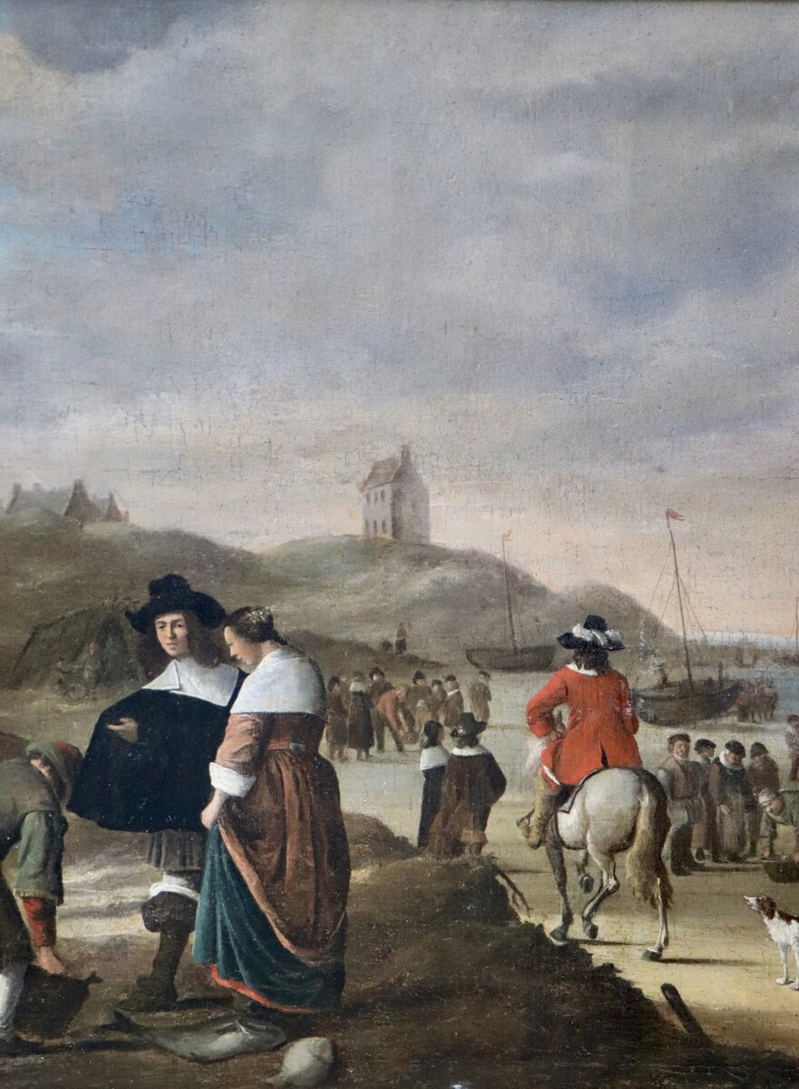 An elegant couple buying fish on the beach