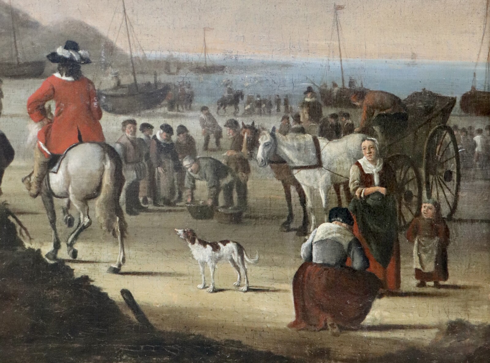 An elegant couple buying fish on the beach