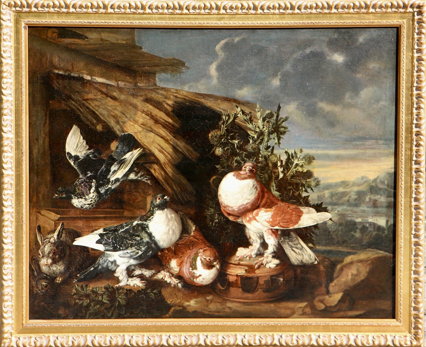 Four pigeons and two rabbits against an Italianate background