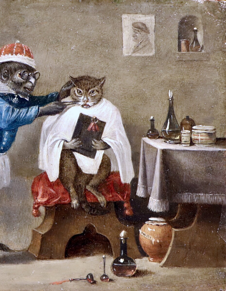 Monkey-trick with a cat at the monkey-barber