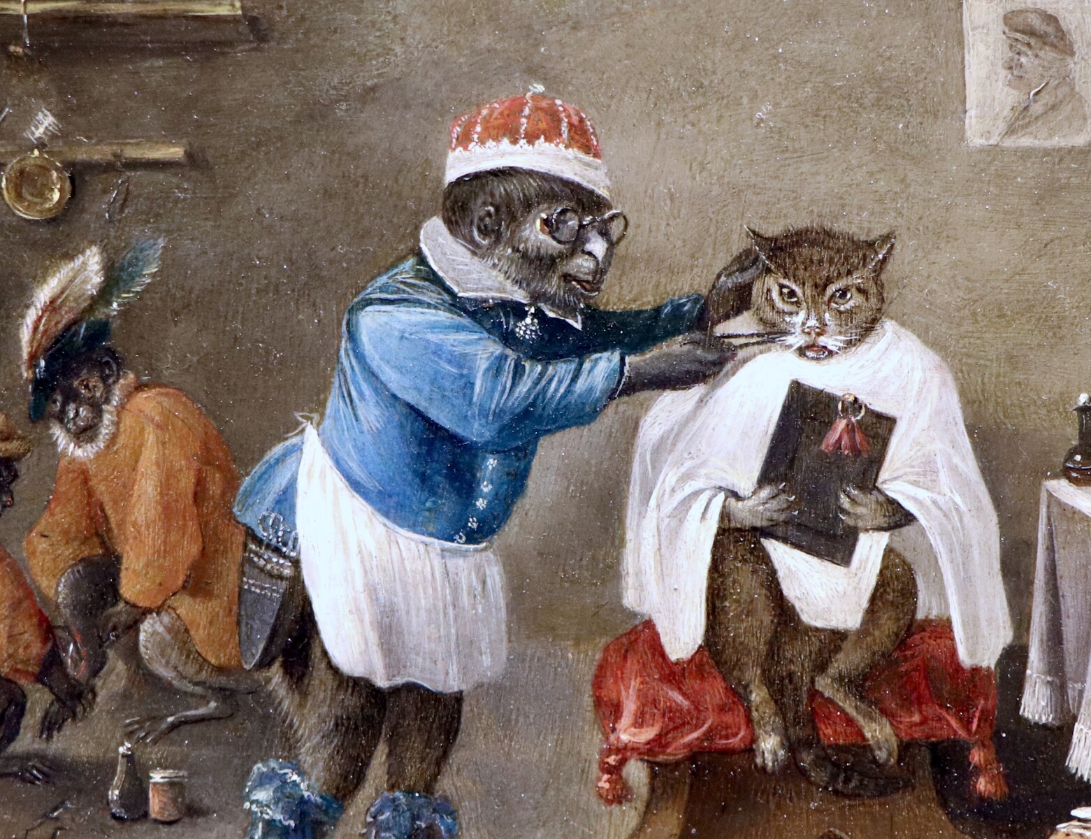 Monkey-trick with a cat at the monkey-barber