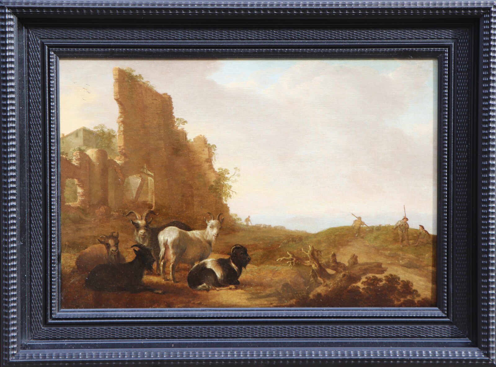 Shepherds with their goats in an Italianate landscape