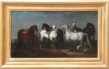 Two stable boys looking after six horses