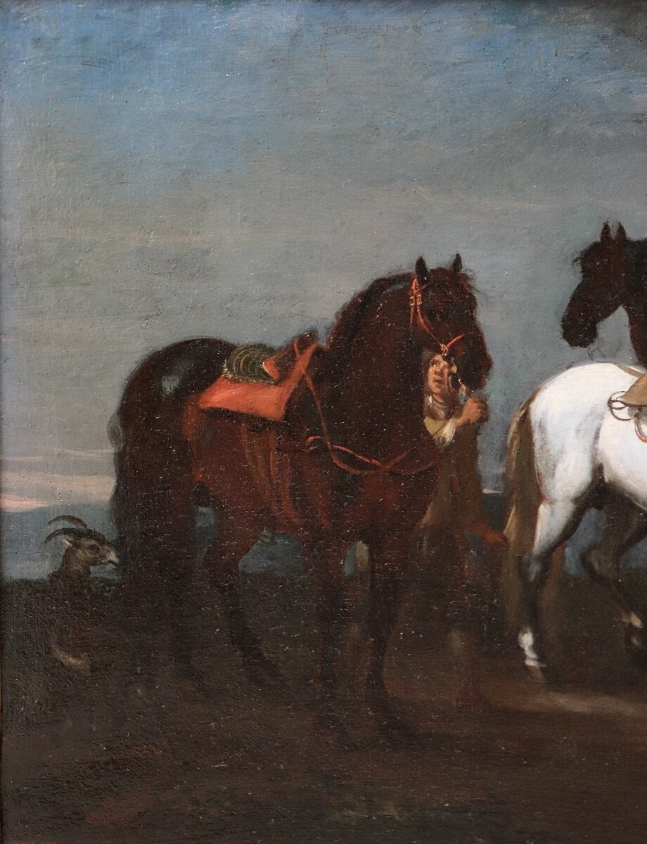 Two stable boys looking after six horses