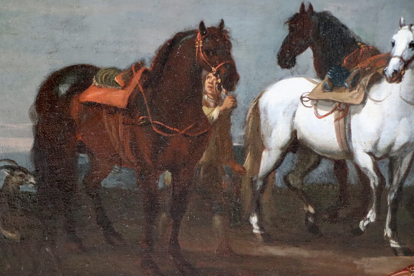 Two stable boys looking after six horses